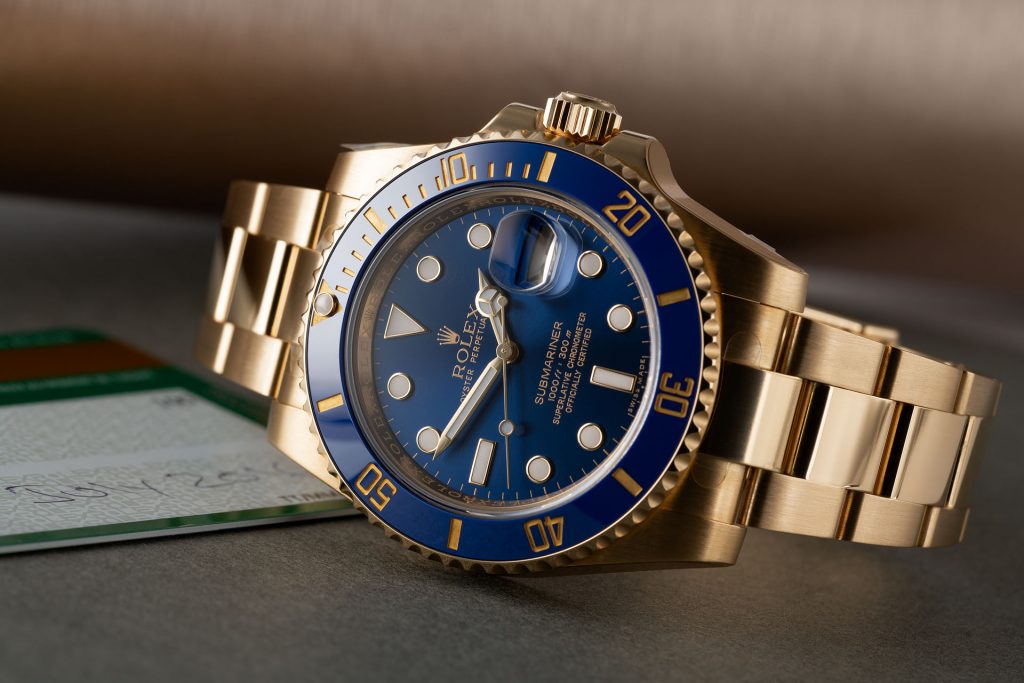 The 18ct gold fake watch has a blue bezel.